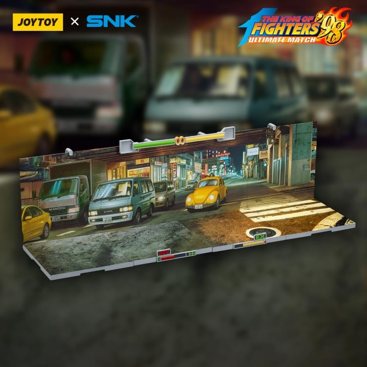 A new fighter is approaching! From the legendary fighting game The King of Fighters '98: Ultimate Match comes a new way to display your favorite heroes and villains duking it out for prizes and glory: the Japan Stage! A diorama base that showcases a busy night street in the middle of a Japanese city, this stage features impressive detailing lifted directly from the game! Get ready for the next round when you order your diorama base today!