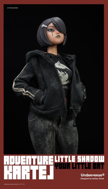 Little Shadow is back! Featuring an all new head sculpt with a classic hoodie, t-shirt, jeans, and high tops outfit. Includes the Skullboom and messenger bag. This is a 1/6 scale figure that comes with multiple interchangeable hands and 25 points of articulation, with a UV female body designed by Ashley Wood.