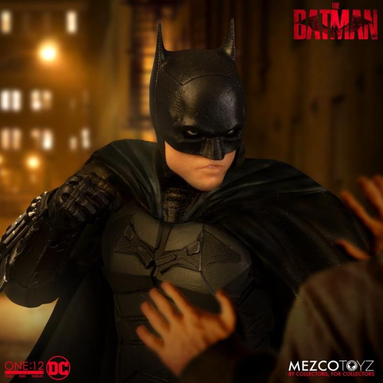 The Batman is outfitted in a screen-accurate armored Batsuit with chest insignia. The costume features an integrated posing wire in the cape, utility belt, a thigh pouch, and two vambrace. Batman comes complete with four head portraits including an unmasked Bruce Wayne portrait, all featuring the likeness of actor Robert Pattinson. Equipped with multiple Batarangs, sticky bombs, handcuffs, grapple launcher, and smoke bombs, Batman fights crime in the wet and grimy streets of Gotham.