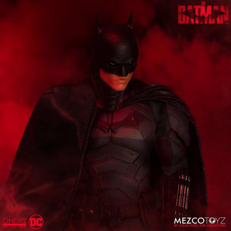 The Batman is outfitted in a screen-accurate armored Batsuit with chest insignia. The costume features an integrated posing wire in the cape, utility belt, a thigh pouch, and two vambrace. Batman comes complete with four head portraits including an unmasked Bruce Wayne portrait, all featuring the likeness of actor Robert Pattinson. Equipped with multiple Batarangs, sticky bombs, handcuffs, grapple launcher, and smoke bombs, Batman fights crime in the wet and grimy streets of Gotham.