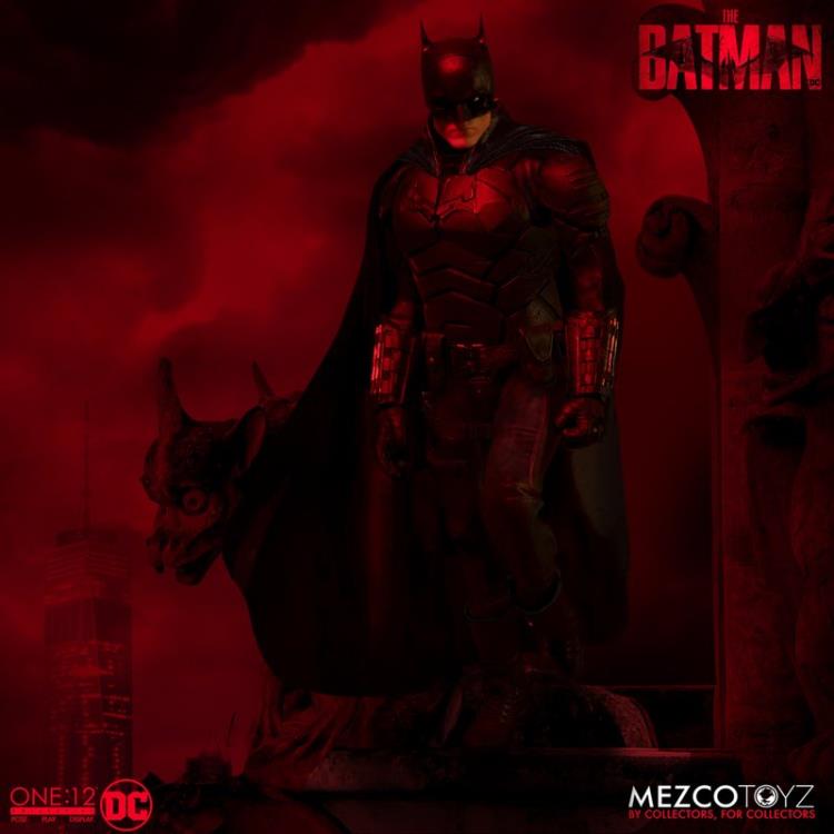 The Batman is outfitted in a screen-accurate armored Batsuit with chest insignia. The costume features an integrated posing wire in the cape, utility belt, a thigh pouch, and two vambrace. Batman comes complete with four head portraits including an unmasked Bruce Wayne portrait, all featuring the likeness of actor Robert Pattinson. Equipped with multiple Batarangs, sticky bombs, handcuffs, grapple launcher, and smoke bombs, Batman fights crime in the wet and grimy streets of Gotham.