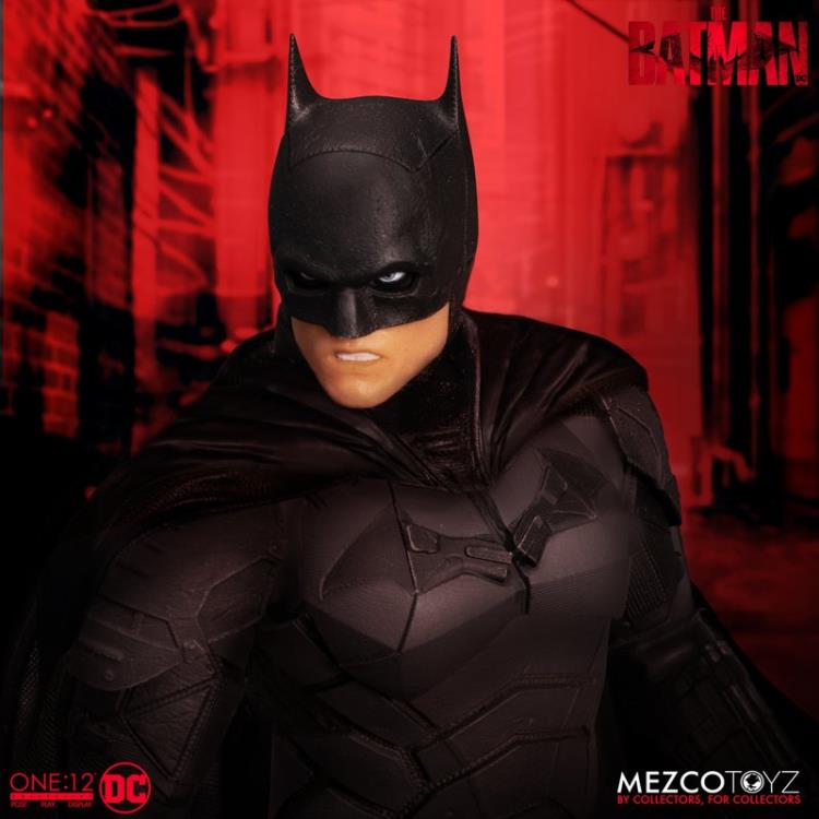 The Batman is outfitted in a screen-accurate armored Batsuit with chest insignia. The costume features an integrated posing wire in the cape, utility belt, a thigh pouch, and two vambrace. Batman comes complete with four head portraits including an unmasked Bruce Wayne portrait, all featuring the likeness of actor Robert Pattinson. Equipped with multiple Batarangs, sticky bombs, handcuffs, grapple launcher, and smoke bombs, Batman fights crime in the wet and grimy streets of Gotham.